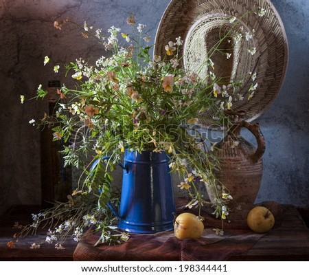 Still life with wildflowers and yellow apples