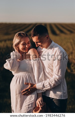 Happy husband stroking feed pregnant wife 
