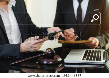 Searching Browsing Internet Data Information Networking Concept with blank search bar.justice and law concept.Male judge in a courtroom with the gavel,working with digital tablet computer.

