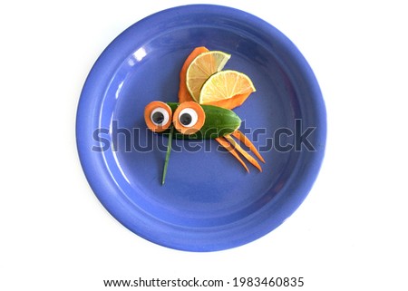Food art creative concepts. Funny mosquito fly made of fruits and vegetables, such as carrots and cucumber isolated on a white background.