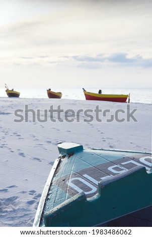 fishing boats on sandy beach - vertical photo