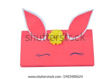 A hand-made paper box placed on top of a white isolated paper background