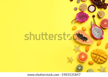 Many different delicious exotic fruits on yellow background, flat lay. Space for text