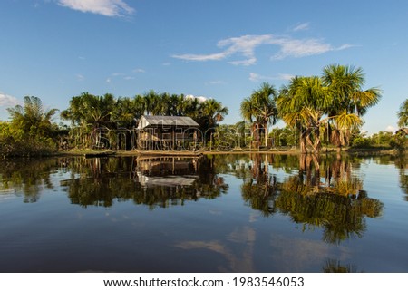 very common house on the bank of the Nanay river, in Iquitos Peru Royalty-Free Stock Photo #1983546053