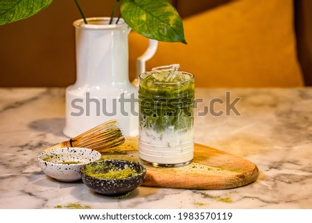 Homemade Iced Matcha Green Tea Latte with bamboo and matcha tea powder