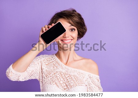 Photo of cheerful pretty person hand show display covering eye toothy smile isolated on violet color background