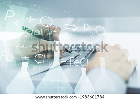 Creative chemistry concept with hand writing in notebook on background with laptop. Multiexposure