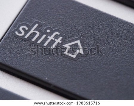 Shift button with an arrow pointing up on a notebook keyboard in macro view