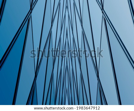 Double exposure of an office building exterior. Glass and metal pattern of wall reflecting sky. Abstract modern architecture background. Geometric structure with triangular and polygonal ornament.