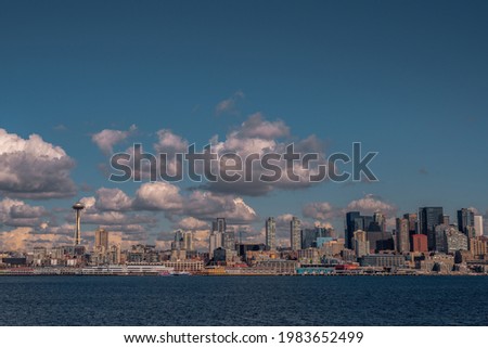 SEATTLE WATERFRONT FROM ELLIOTT BAY WITH PUFFY WHITE CLOUDS Royalty-Free Stock Photo #1983652499