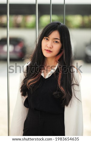 portrait of beautiful long hair asian thailand teenager in working uniform with smily face