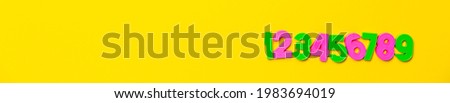 Numbers set 1, 2, 3, 4, 5, 6, 7, 8, 9. Colorful plastic numerals isolated on yellow background. Poster or site head. Preschool distance education banner. Math online course. Funny count. Copy space.
