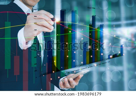 A man wearing a suit on his left hand holding a cell phone His right hand poked a pencil on a stock chart. Globe background and blurred lights