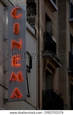Close-up on a neon light shaped into the French word "Cinéma".