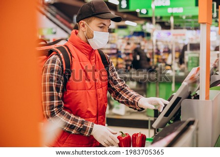 Food delivery man buying products at grocery store