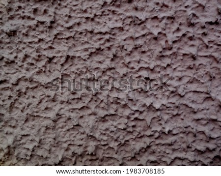 Textured brown-coffee dark wall surface, treated with decorative plaster technology.
