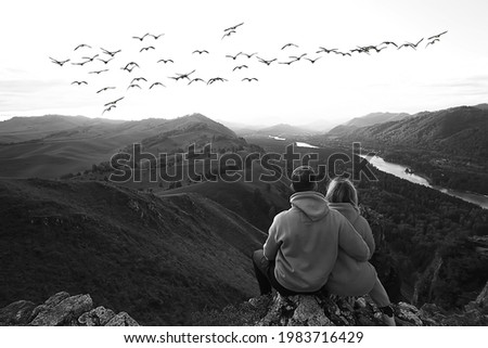 freedom concept, couple in love in a landscape with birds flying