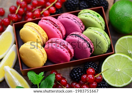 French food, colorful macaroons on wooden background, closeup.