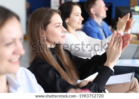 Team of business people applauding at seminar Royalty-Free Stock Photo #1983752720
