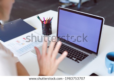 African american woman using laptop with copy space on screen. independent creative business at a modern office.