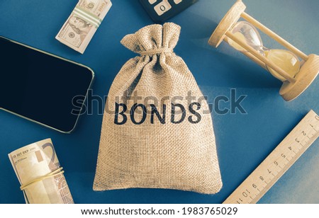 Money bag with the word Bonds. A bond is a security that indicates that the investor has provided a loan to the issuer. Equivalent loan. Unsecured and secured bonds. Royalty-Free Stock Photo #1983765029