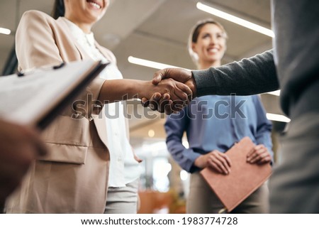 Close-up of corporate managers handshaking after successful agreement in the office. Royalty-Free Stock Photo #1983774728