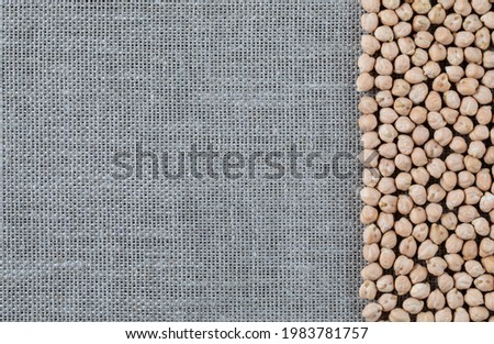 Turkish peas - chickpeas for cooking traditional dishes of Egypt, Israel and Greece - falafel and hummus. Food background on a linen canvas
