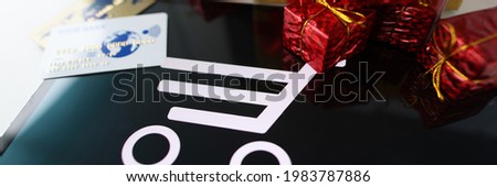 Lots of gifts and plastic credit card are on tablet