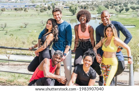 Group portrait of runners smiling at camera.