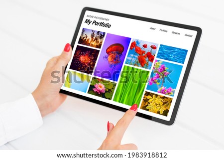 Person viewing nature photography portfolio website on tablet