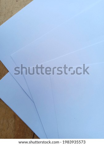 white paper on a wooden board background