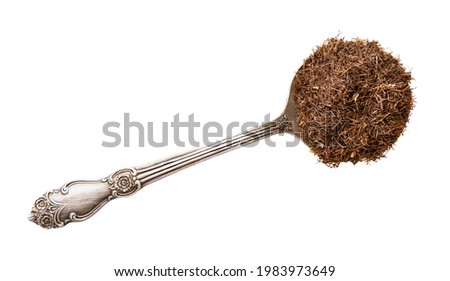 top view of grinded dried corn silk in silver tablespoon isolated on white background