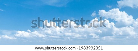 Panoramic photo of a blue sky with cumulus clouds. Royalty-Free Stock Photo #1983992351