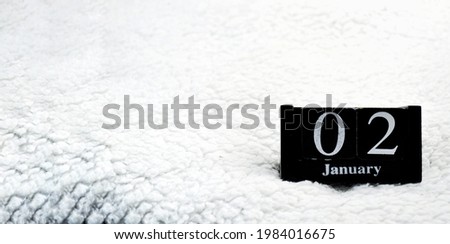 Wooden calendar from blocks on a white textile background with copy space. Banner. 2nd of January. Science fiction day