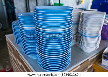A pile of plastic bowls of a noodle shop at thailand.
