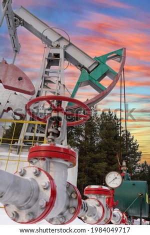 Manometer Pipeline Oil pressure gauge shows 0 kgf-cm2. Oil crude pump jack usa winter working. Oil rig energy industrial machine for petroleum in the sunset background for design. Sunrise sunset sky