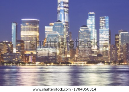 Defocused picture of New York City night skyline, abstract urban background, color toning applied, USA.