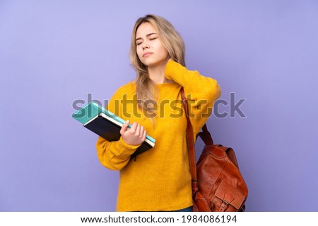 Teenager Russian student girl isolated on purple background with neckache