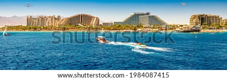 Panoramic view on central public beach with water sport activities– famous tourist resort city in Eilat - famous resort city in Israel, Middle East Royalty-Free Stock Photo #1984087415