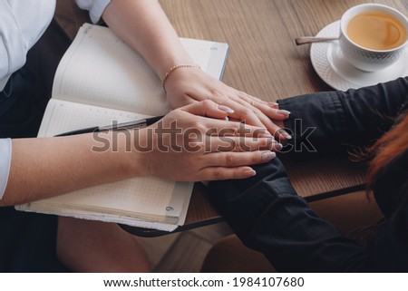 Empathy, friendly support, each other's support and sisterhood. Young woman comforting her friend sitting in cafe. Female Psychotherapist supporting her depressed patient. Royalty-Free Stock Photo #1984107680