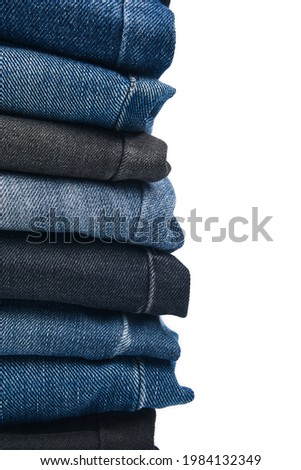 Stack of Various Shades Of Blue Jeans On White Background Denim jeans texture. Denim background texture for design. Canvas denim texture. Blue denim that can be used as background. Royalty-Free Stock Photo #1984132349