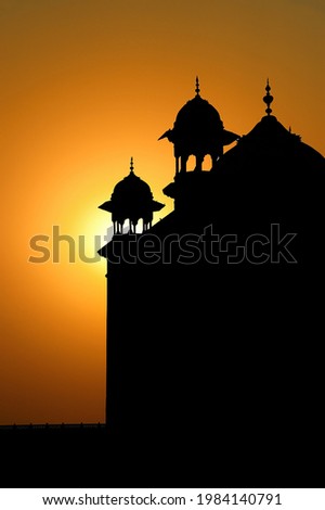 Silhouette at sunrise of the arches of the Taj Mahal, Agra, India
