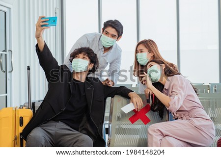 Group of tourists taking a selfie in the airport before their flight
