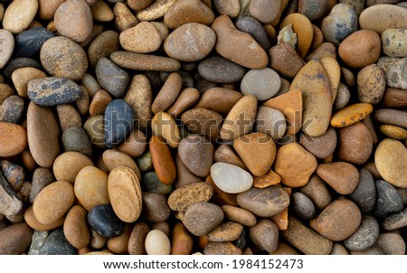 boulder pebble beach stones background seamless texture for design use, Naturally rounded gravel at sea shore Nature background texture pattern Royalty-Free Stock Photo #1984152473