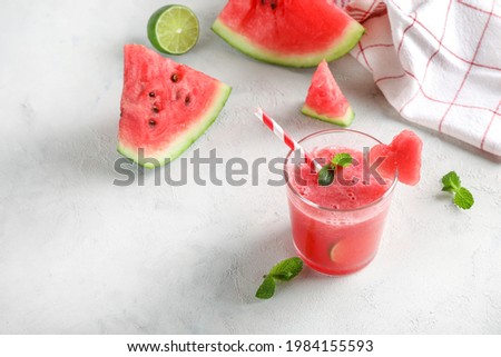 Fresh tasty watermelon smoothie in glass on white background.