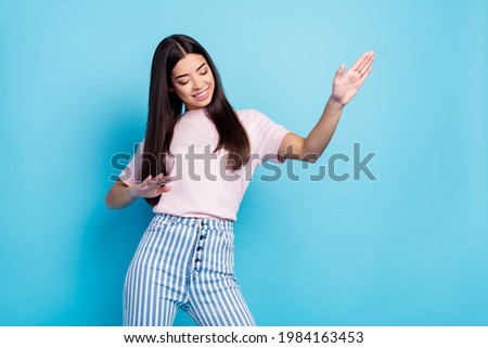 Photo of attractive happy positive young woman dance good mood wear casual clothes isolated on blue color background