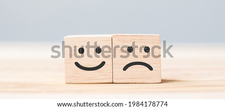 emotion face symbol on wooden cube blocks. Service rating, ranking, customer review, satisfaction and feedback concept