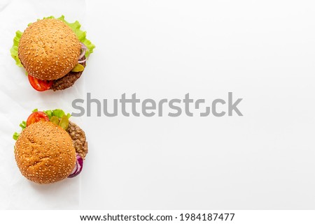 Hamburgers isolated on white with beef meat steak and vegetales
