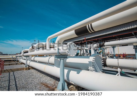 Steel long pipes and pipe elbow in station oil factory during refinery Petrochemistry industry in gas site distillery. Royalty-Free Stock Photo #1984190387