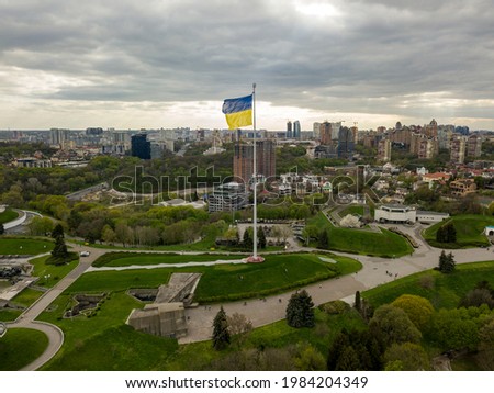 Flag of Ukraine on a high flagpole. Aerial drone view.